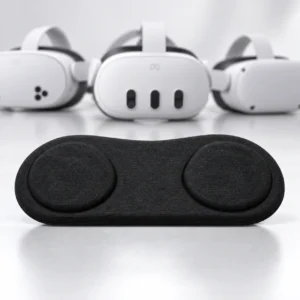 Three white VR headsets behind a black accessory with two round panels
