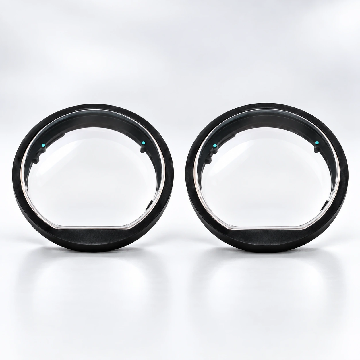 Pair of black round lens inserts on a white background