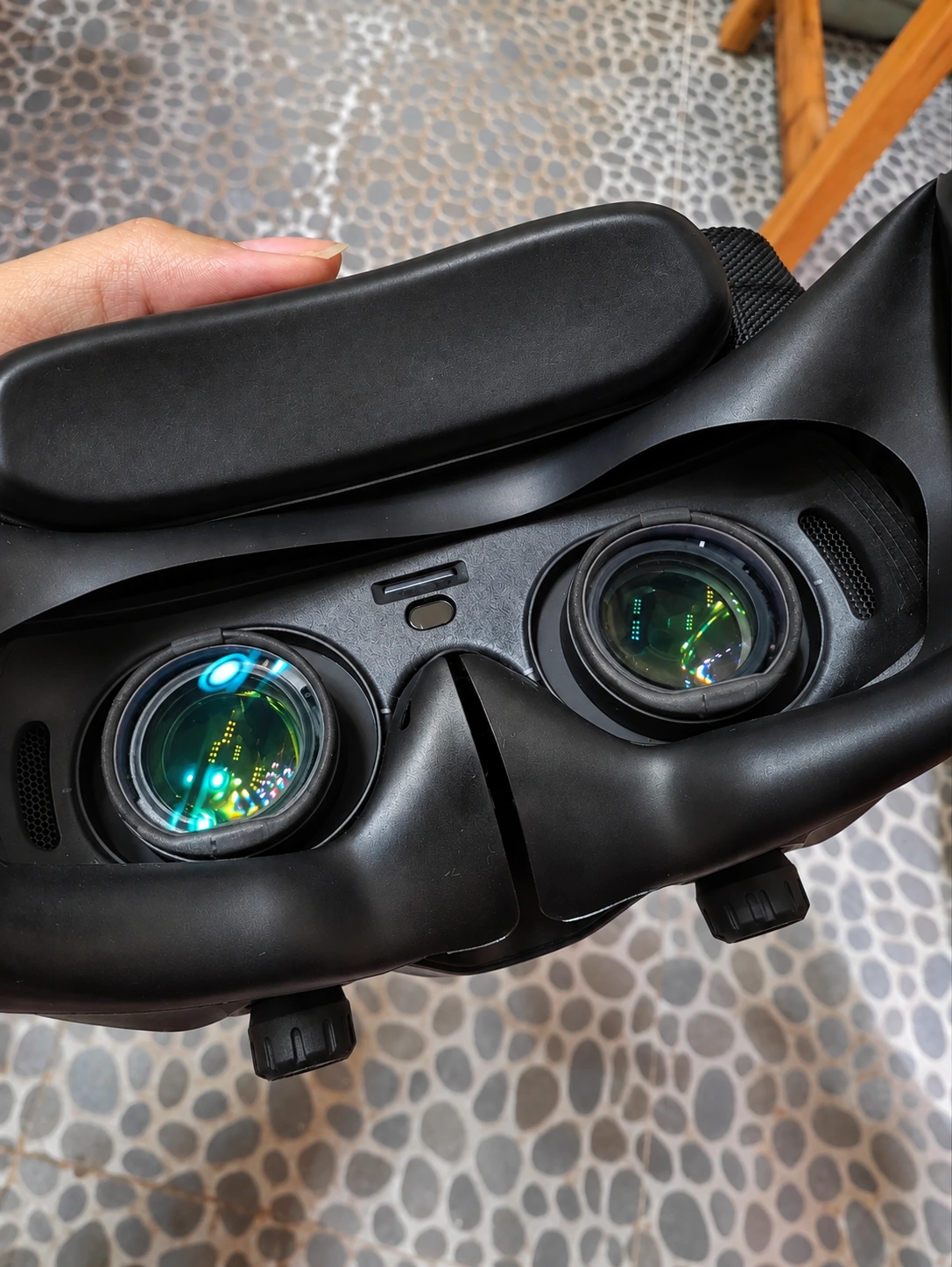 Handheld DJI Goggles 3 showing the two inner eyepieces