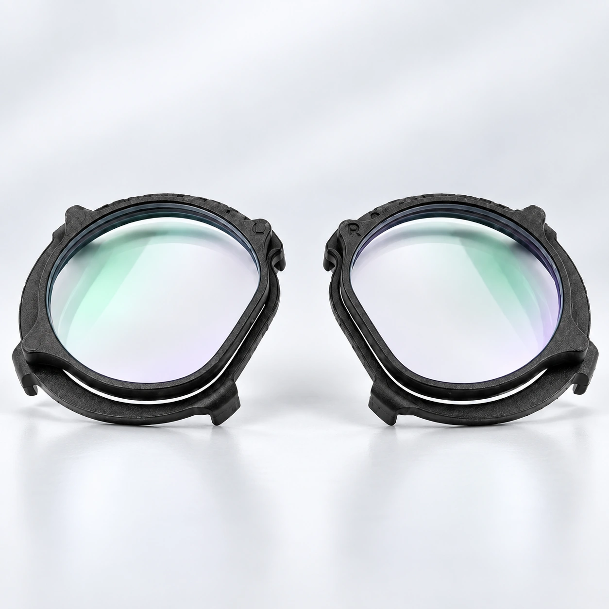Pair of clear VR lens inserts with black frames on a white background