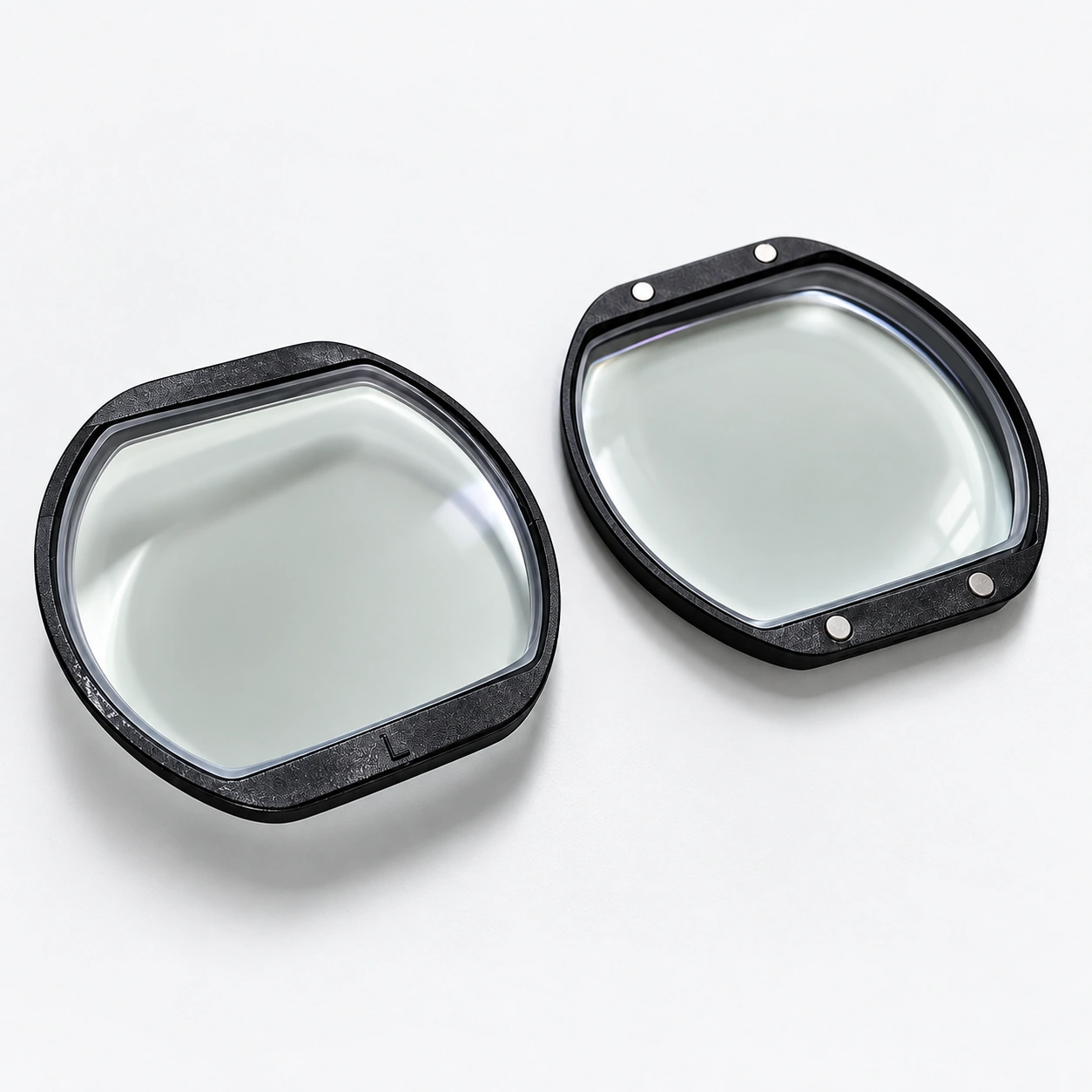 Angled view of two black lens inserts on a white background