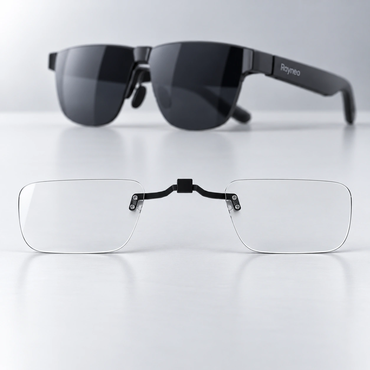 Black RayNeo glasses with a clear lens insert displayed below