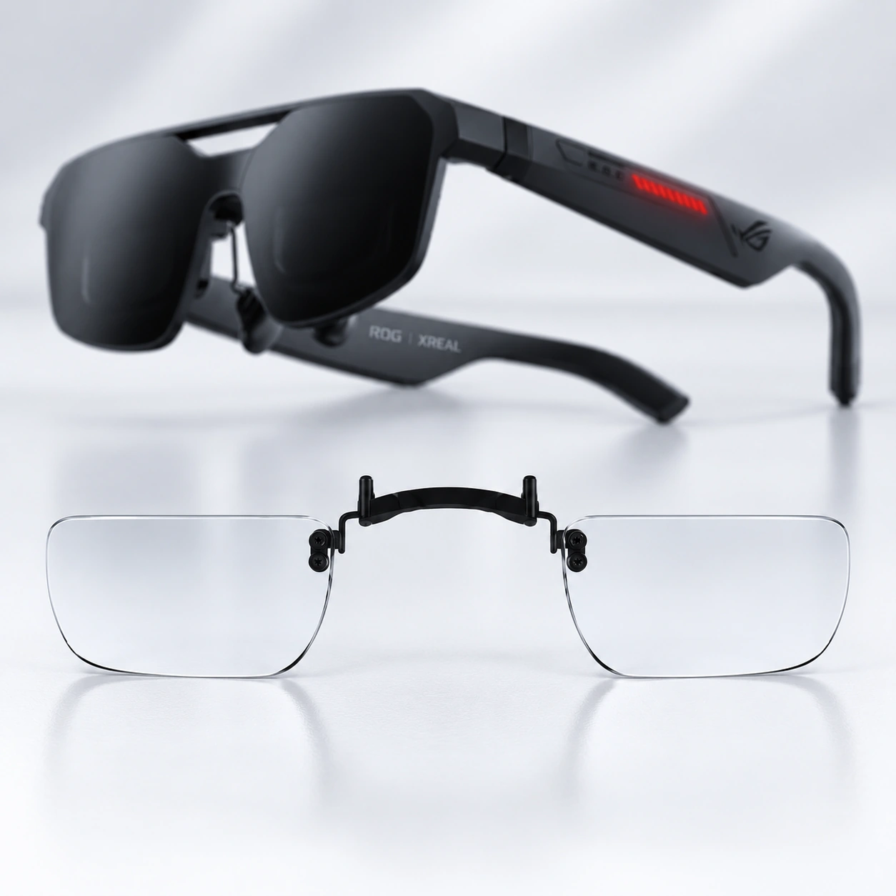 Black ROG XREAL glasses with a clear lens insert displayed below