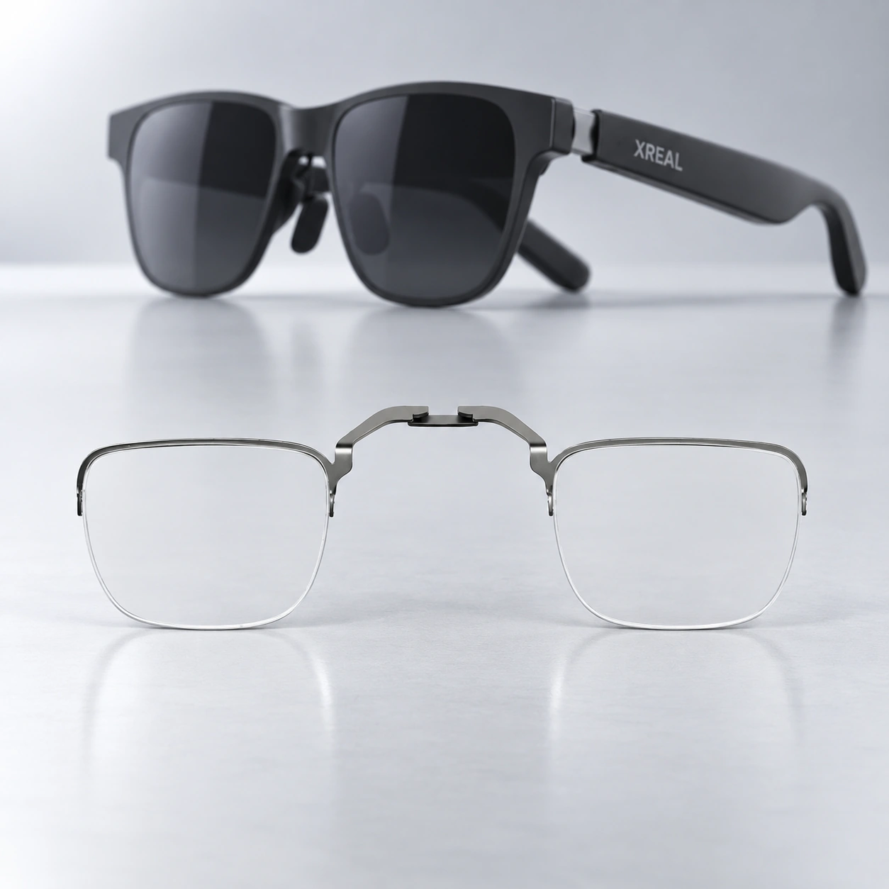 Black XREAL glasses with a clear lens insert displayed below
