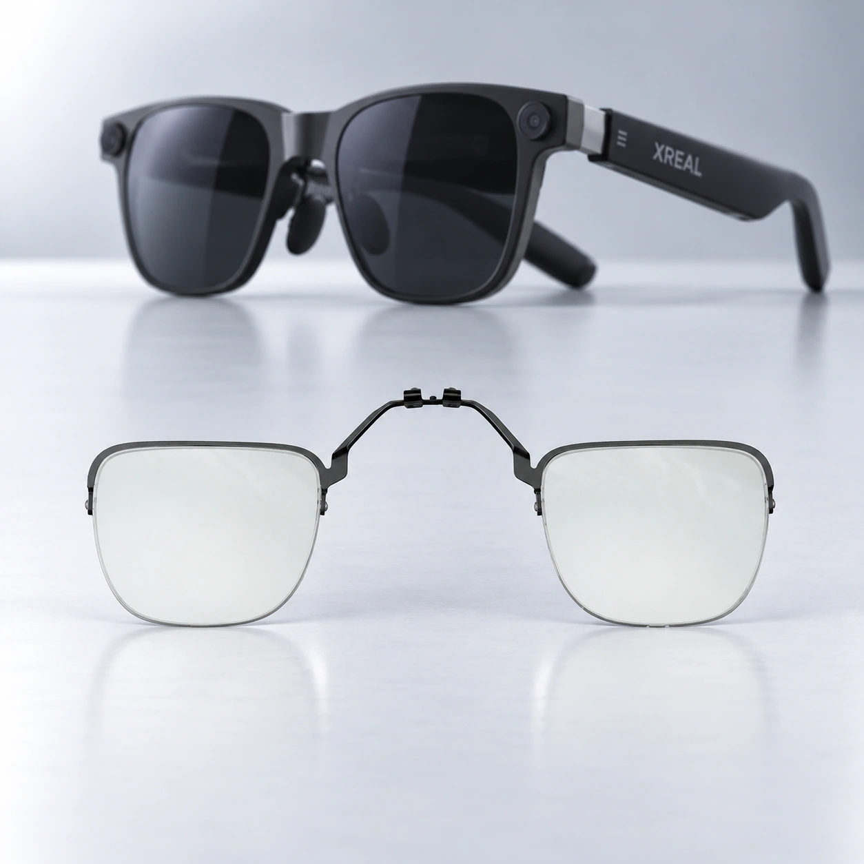 Black XREAL glasses with a clear lens insert displayed below