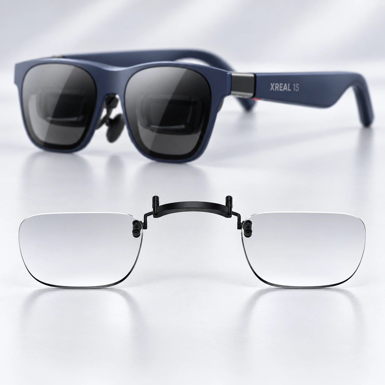 Blue XREAL glasses with a clear lens insert displayed below