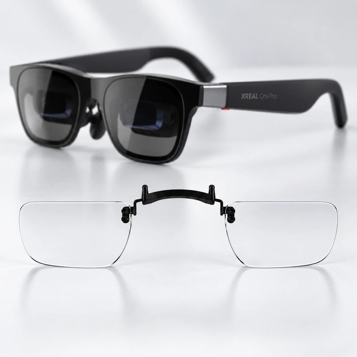Black XREAL glasses with a clear lens insert displayed below