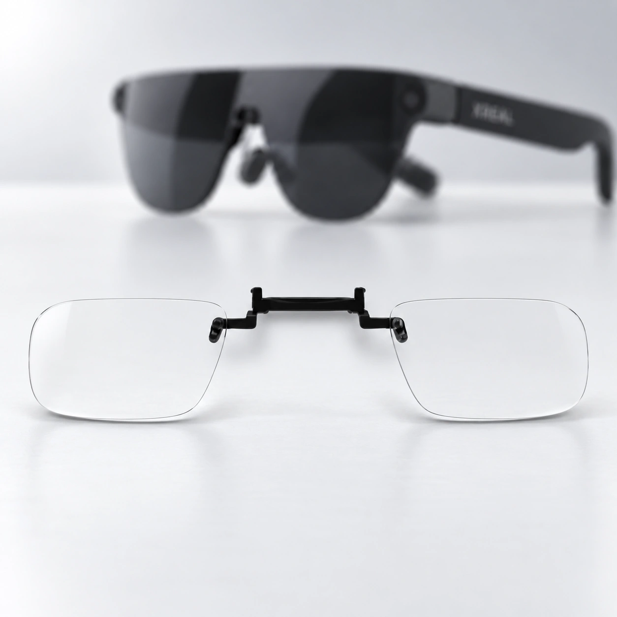 Black AR glasses with a clear lens insert displayed below