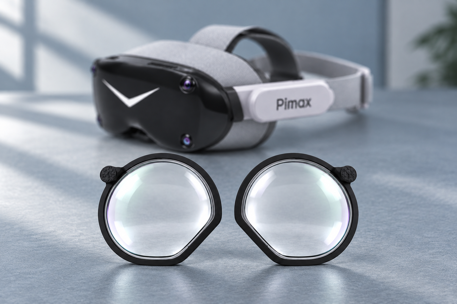 Black-and-white Pimax headset behind two black-framed inserts on a blue-gray work-surface background.
